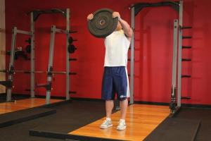 Exercises with a barbell plate: training in the gym